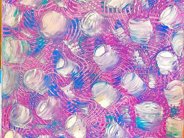 A close up of the water bubbles on a pink background