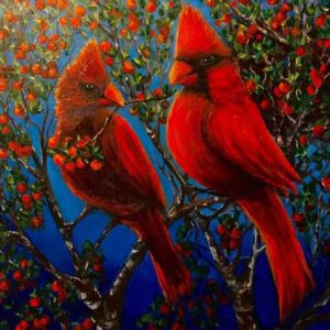 Two red birds sitting on a tree branch.
