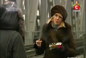 A woman in fur jacket and hat smoking.