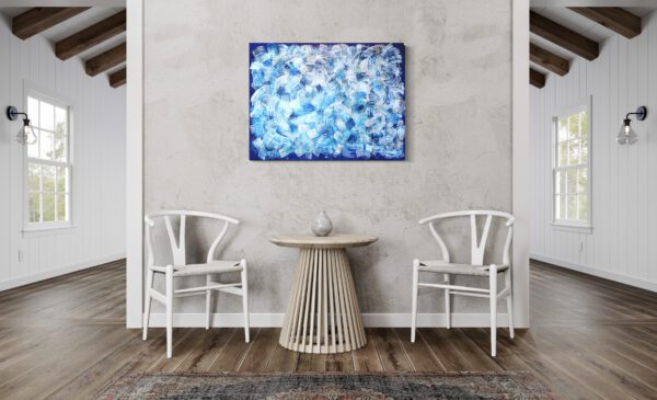 A painting of blue flowers on the wall above two chairs.