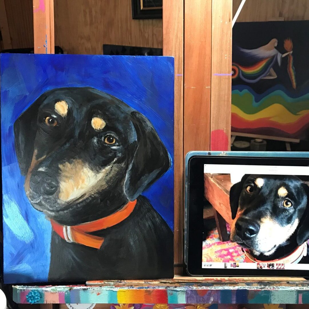 A painting of a dog is shown on the easel.
